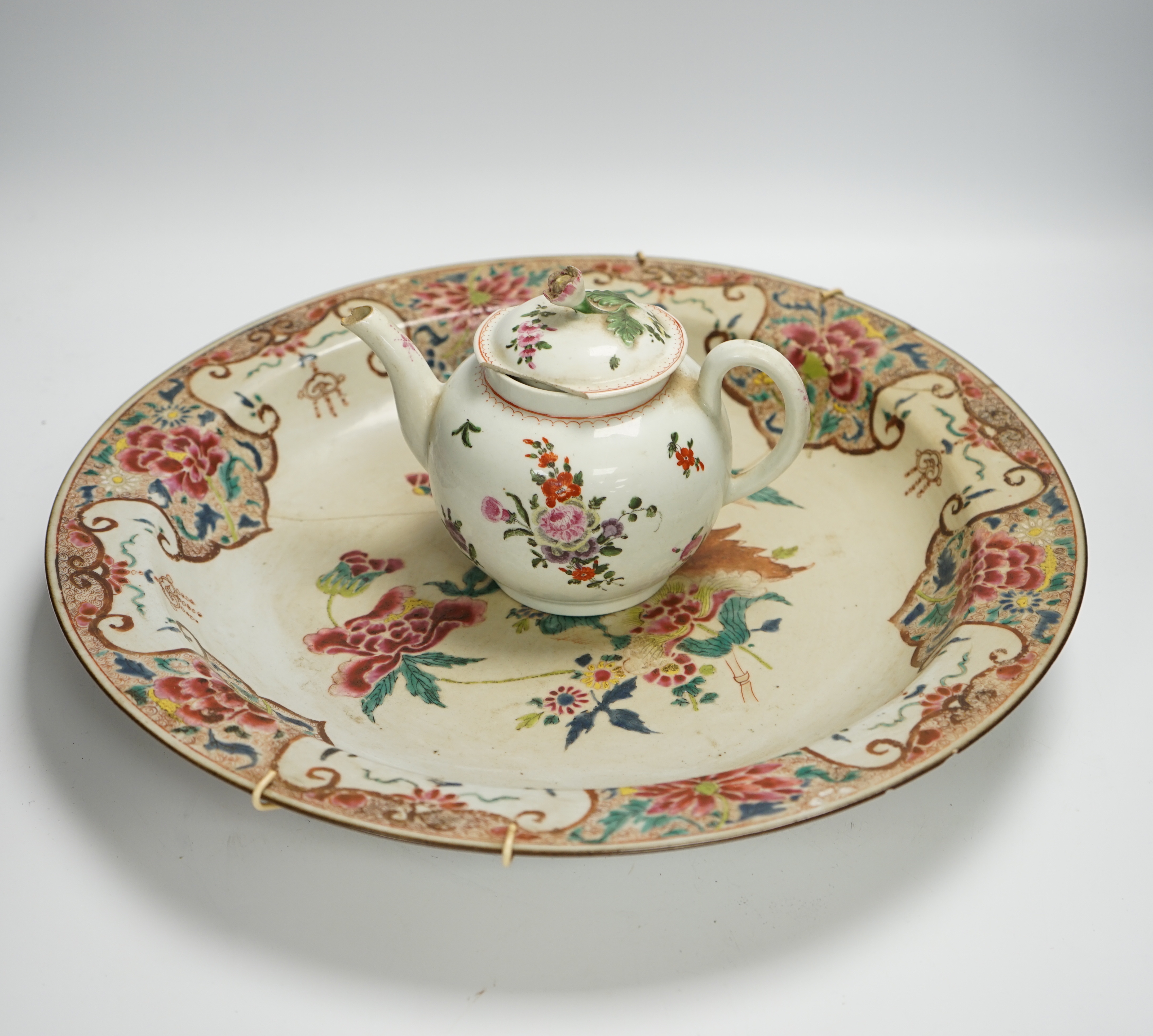 A Worcester teapot, c.1770, two 18th century Chinese porcelain dishes, a cup and saucer, a Chinese shallow bowl and a small teapot, largest dish 39cm